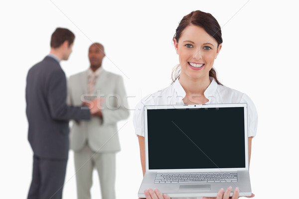 Tradeswoman showing notebook with colleagues behind her against a white background Stock photo © wavebreak_media