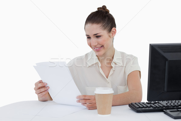 Happy businesswoman looking a document against a white background Stock photo © wavebreak_media