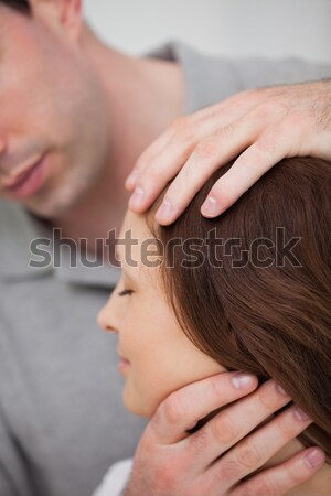 Close-up of a doctor examining the neck of a patient in a room Stock photo © wavebreak_media