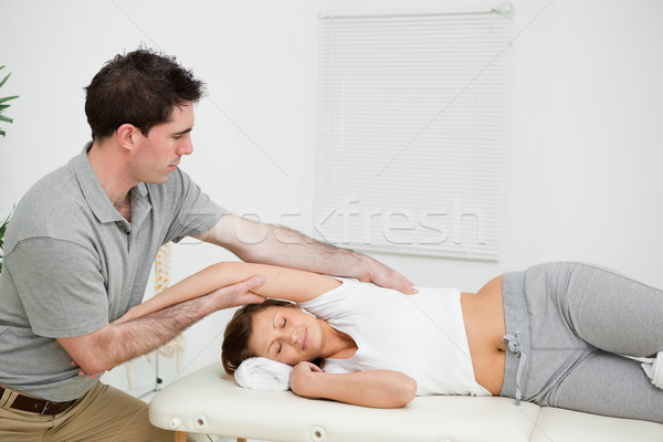 Peaceful woman being stretched in a medical room Stock photo © wavebreak_media