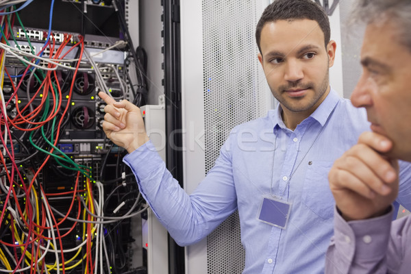 Two technicians looking at wiring of servers in data center Stock photo © wavebreak_media