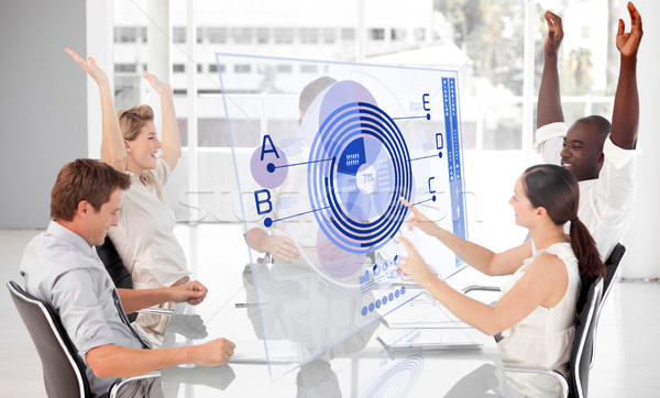 Stock photo: Cheerful business workers using blue diagram interface