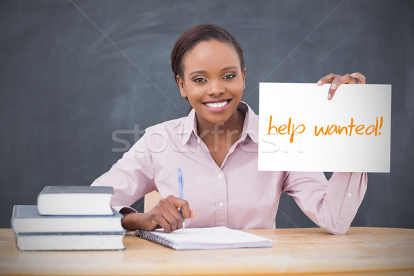 Happy teacher holding page showing help wanted Stock photo © wavebreak_media