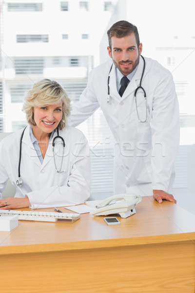 Smiling doctors with computer at medical office Stock photo © wavebreak_media