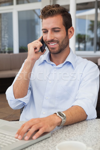 Feliz empresario hablar teléfono usando la computadora portátil patio Foto stock © wavebreak_media