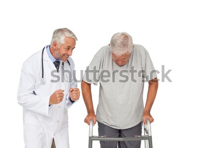 Doctor with senior man using walker Stock photo © wavebreak_media