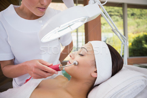 Peaceful brunette getting micro dermabrasion from beauty therapi Stock photo © wavebreak_media