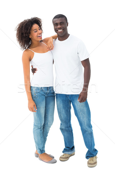 Casual couple in jeans and white tops posing Stock photo © wavebreak_media