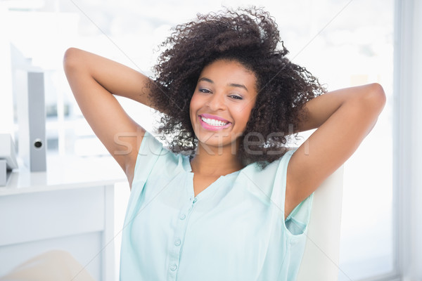 Happy businesswoman relaxing in swivel chair Stock photo © wavebreak_media
