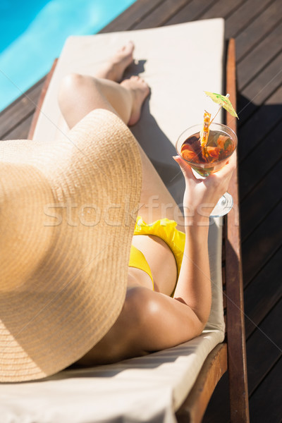 Beautiful woman holding drink by swimming pool Stock photo © wavebreak_media