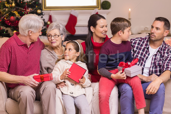 Multi generation family holding presents on sofa Stock photo © wavebreak_media