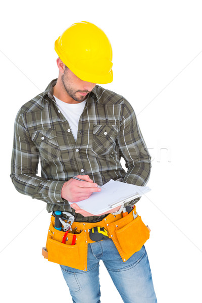 Stock photo: Manual worker writing on clipboard