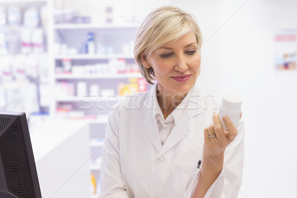 Pharmacist holding medicine jar Stock photo © wavebreak_media