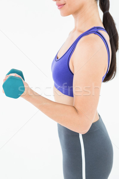 Fit woman lifting dumbbell  Stock photo © wavebreak_media