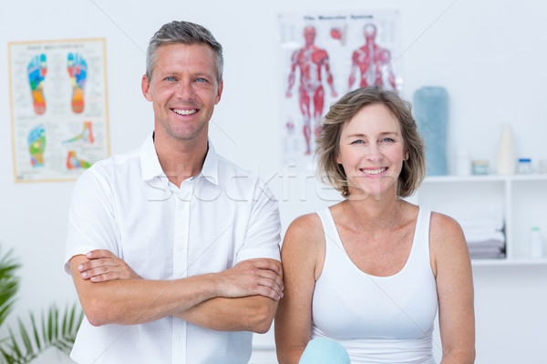 Doctor and patient smiling at camera Stock photo © wavebreak_media