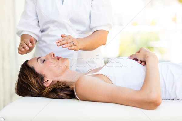 Calm woman receiving reiki treatment Stock photo © wavebreak_media