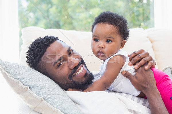 Happy father with baby girl on couch Stock photo © wavebreak_media