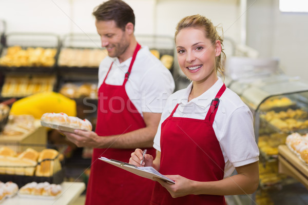 Portrait of a smiling baker with her colleague Stock photo © wavebreak_media