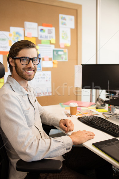 Stock photo: Portrait of smiling designer sitting at creative office