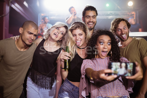 Cheerful young friends talking selfie at nightclub Stock photo © wavebreak_media