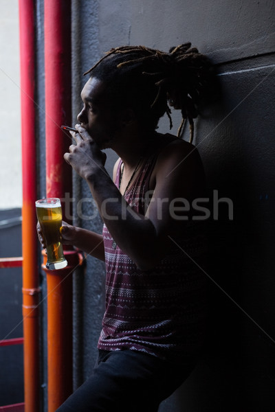Man smoking while having beer Stock photo © wavebreak_media