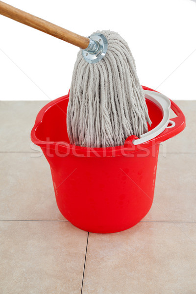 Stock photo: Mop in red bucket on tile floor
