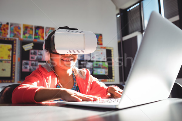 Sorridere ragazza digitando laptop cuffie virtuale Foto d'archivio © wavebreak_media