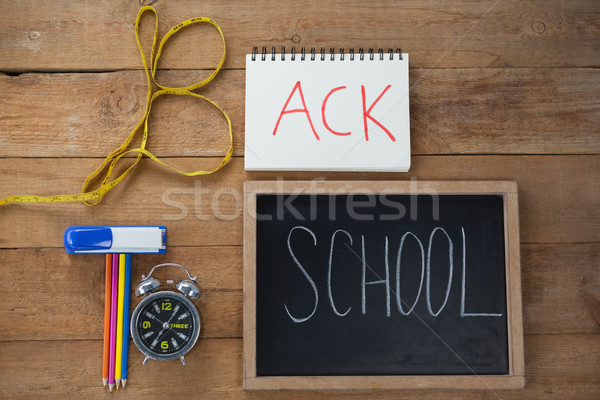 School supplies, alarm clock and measuring tape on wooden table Stock photo © wavebreak_media