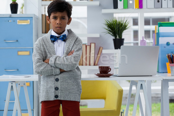Portrait of boy pretending as businessman standing with arms crossed Stock photo © wavebreak_media