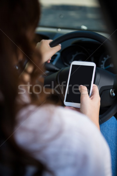 Femme téléphone portable conduite voiture vue arrière Voyage [[stock_photo]] © wavebreak_media