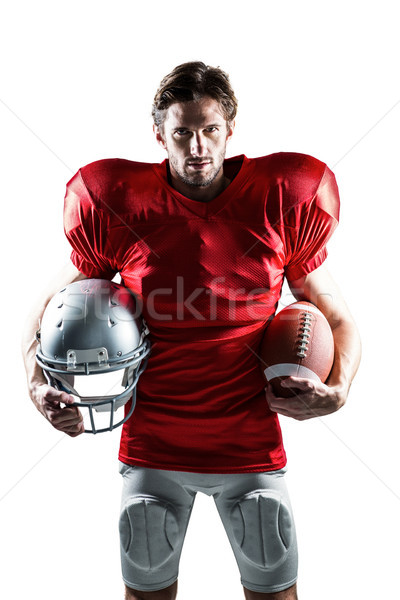 American football player in red jersey holding helmet and ball Stock photo © wavebreak_media