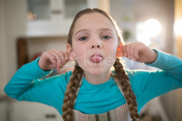 Young girl making funny faces at home Stock photo © wavebreak_media
