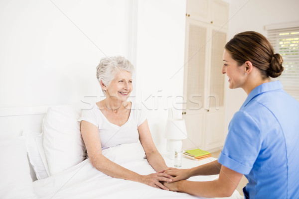 Stock photo: Nurse taking care of suffering senior patient 