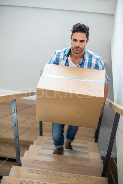 Handsome man holding cardboard box  Stock photo © wavebreak_media