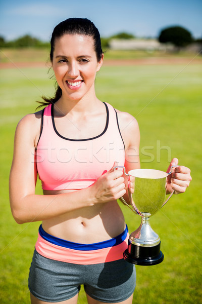 Fericit femeie atlet trofeu victorie Imagine de stoc © wavebreak_media