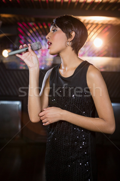 Woman singing in bar Stock photo © wavebreak_media