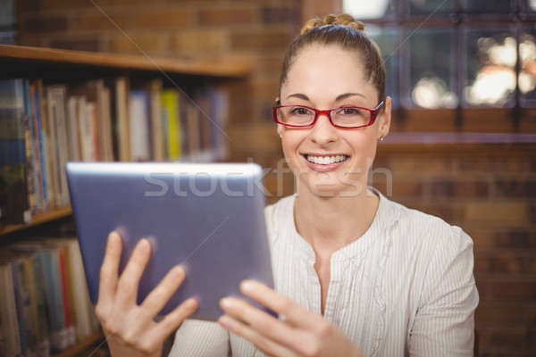 Blonde teacher using tablet in the library Stock photo © wavebreak_media