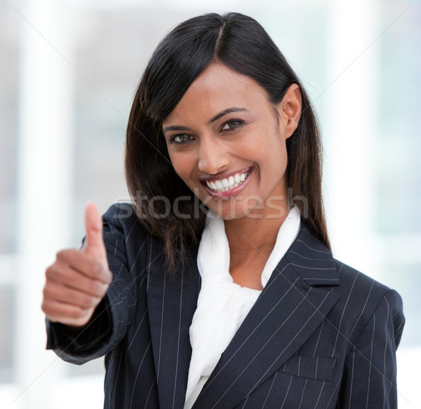 Cheerful businesswoman with a thumb up standing  Stock photo © wavebreak_media
