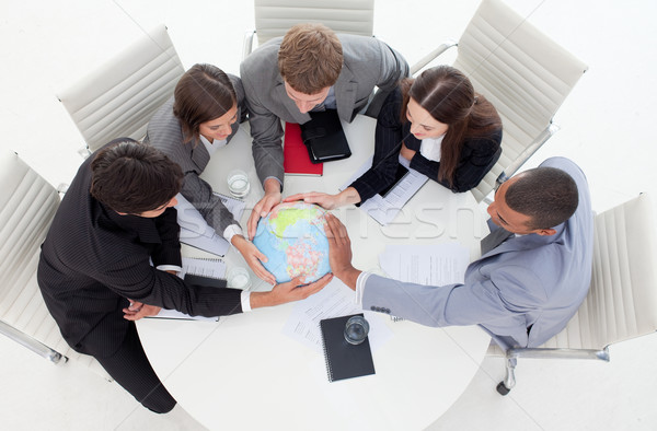 High angle of a business people holding a terrestrial globe  Stock photo © wavebreak_media