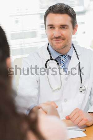 Elderly doctor with folded arms smiling at the camera Stock photo © wavebreak_media