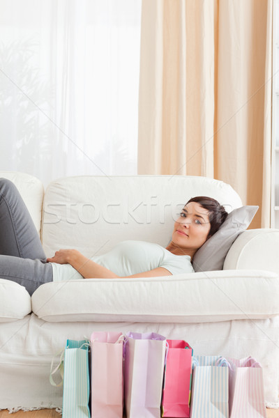 Stock photo: Woman with shopping bags in her living room