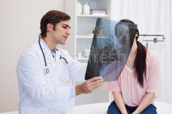 Male doctor analyzing x-ray with his patient Stock photo © wavebreak_media
