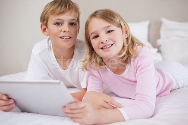 Children using a tablet computer in a bedroom Stock photo © wavebreak_media
