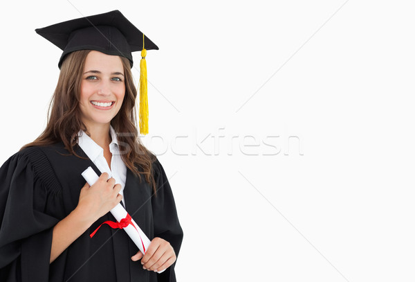 A woman with a degree in her hand as she looks at the camera  Stock photo © wavebreak_media