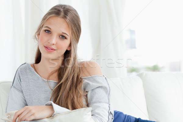 A girl lying across the couch while she looks into the camera  Stock photo © wavebreak_media