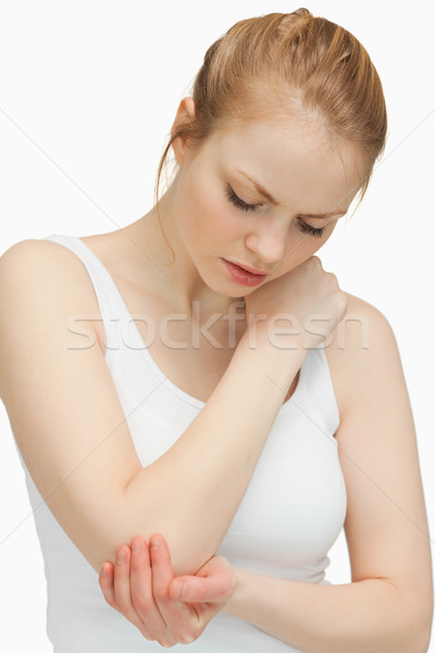 Woman touching her painful elbow against white background Stock photo © wavebreak_media