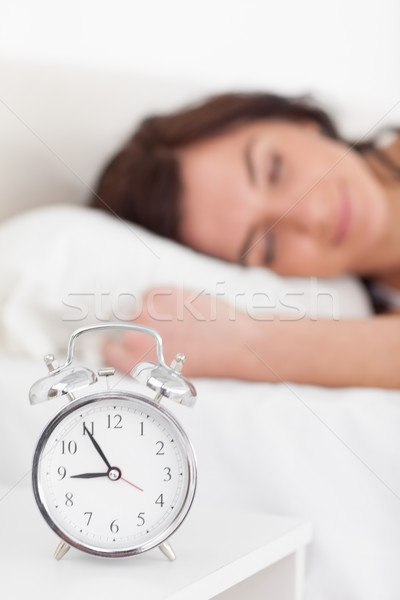 Alarm clock being placed on a nightstand in a bedroom Stock photo © wavebreak_media