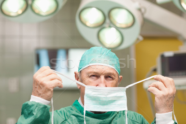 Surgeon getting dressed in a surgical room Stock photo © wavebreak_media