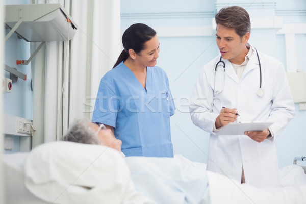 Doctor and nurse talking to a patient in hospital ward Stock photo © wavebreak_media