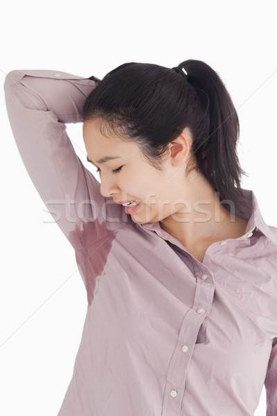 Woman disgusted at her own sweating on white background Stock photo © wavebreak_media